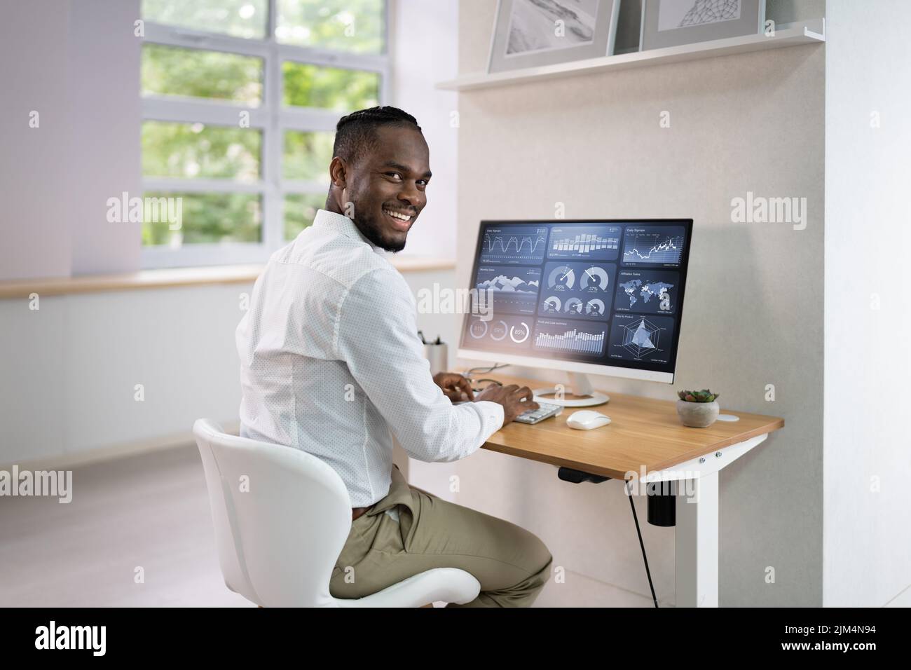 Analyst Man Looking At Business Data Analytics Dashboard Stock Photo