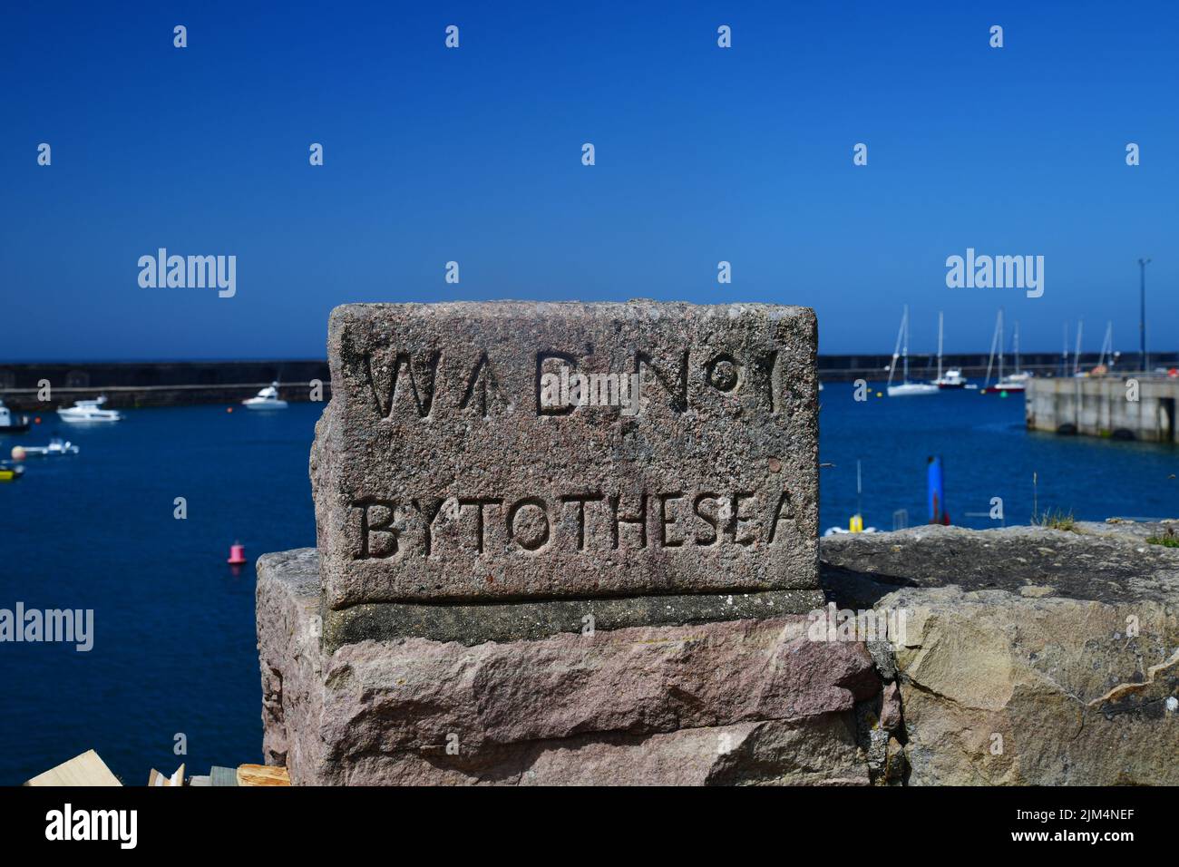 Braye harbour, stone tablet, Alderney, Channel Islands, Great Britain, June 2022. Stock Photo
