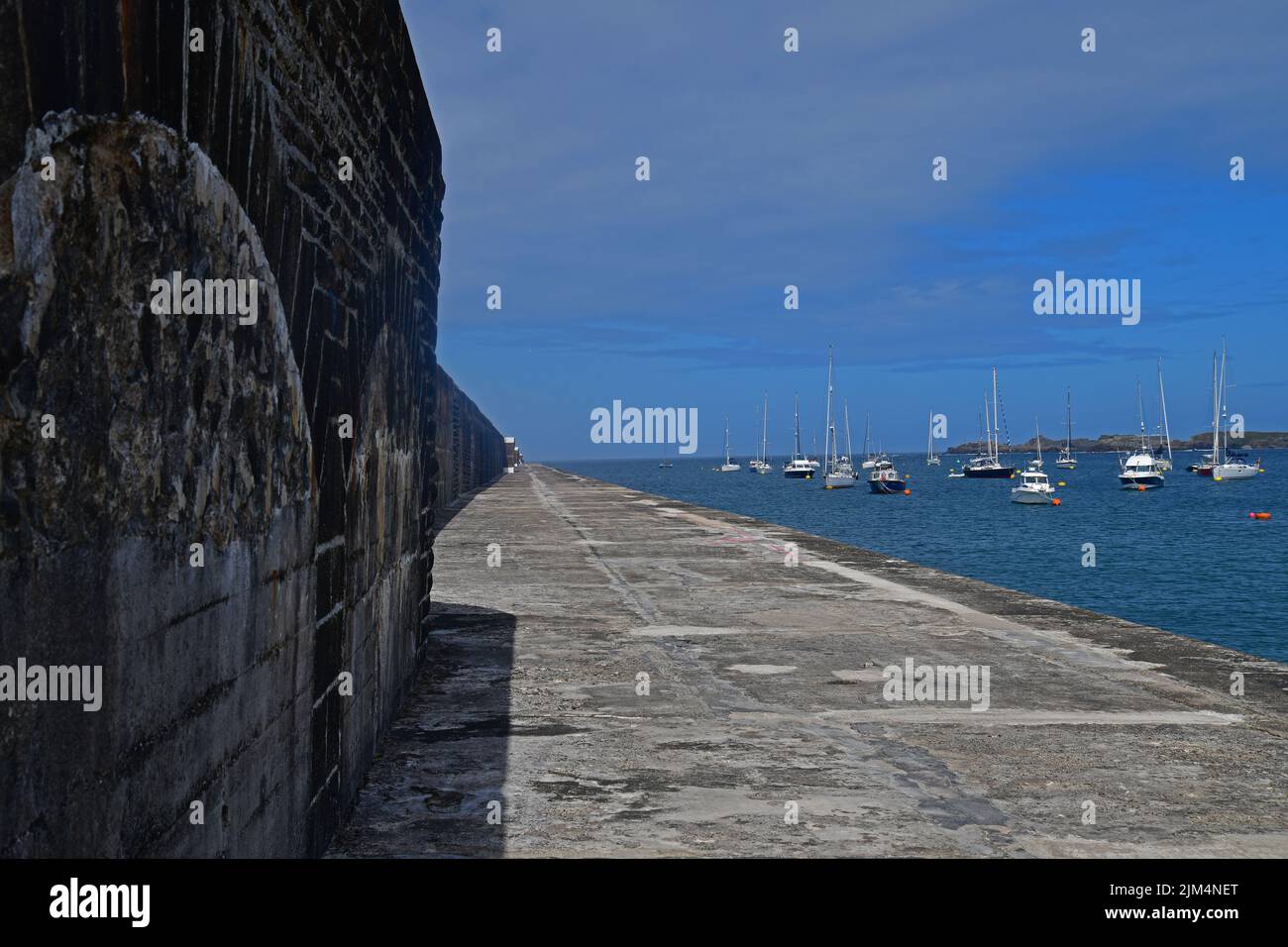 Completed in 1864 the 910m long Braye harbour breakwater is an impressice edifice ,Alderney, Channel Islands, Great Britain, June 2022. Stock Photo