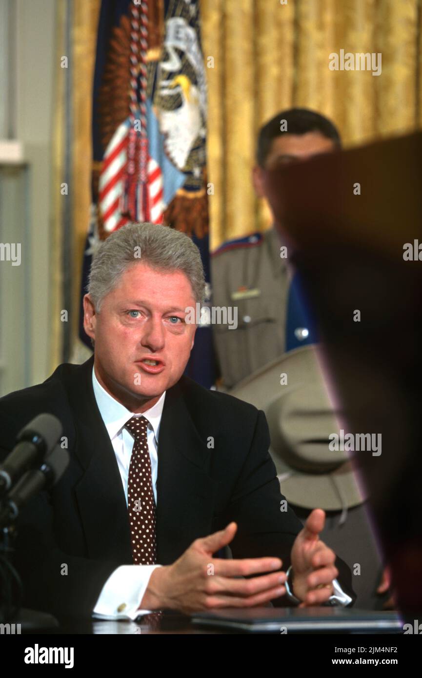 U.S. President Bill Clinton, delivers a televised address during the signing of an executive order on child safety gun locks from the Oval Office of the White House, March 6, 1997 in Washington, D.C. Stock Photo