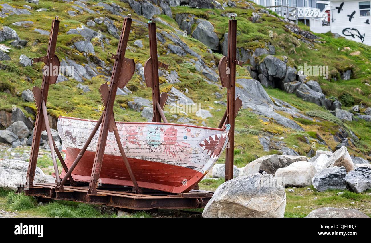 Old wooden fishing boat with decorative painting on land in The Old Colonial Harbour, Nuuk, Greenland on 20 July 2022 Stock Photo