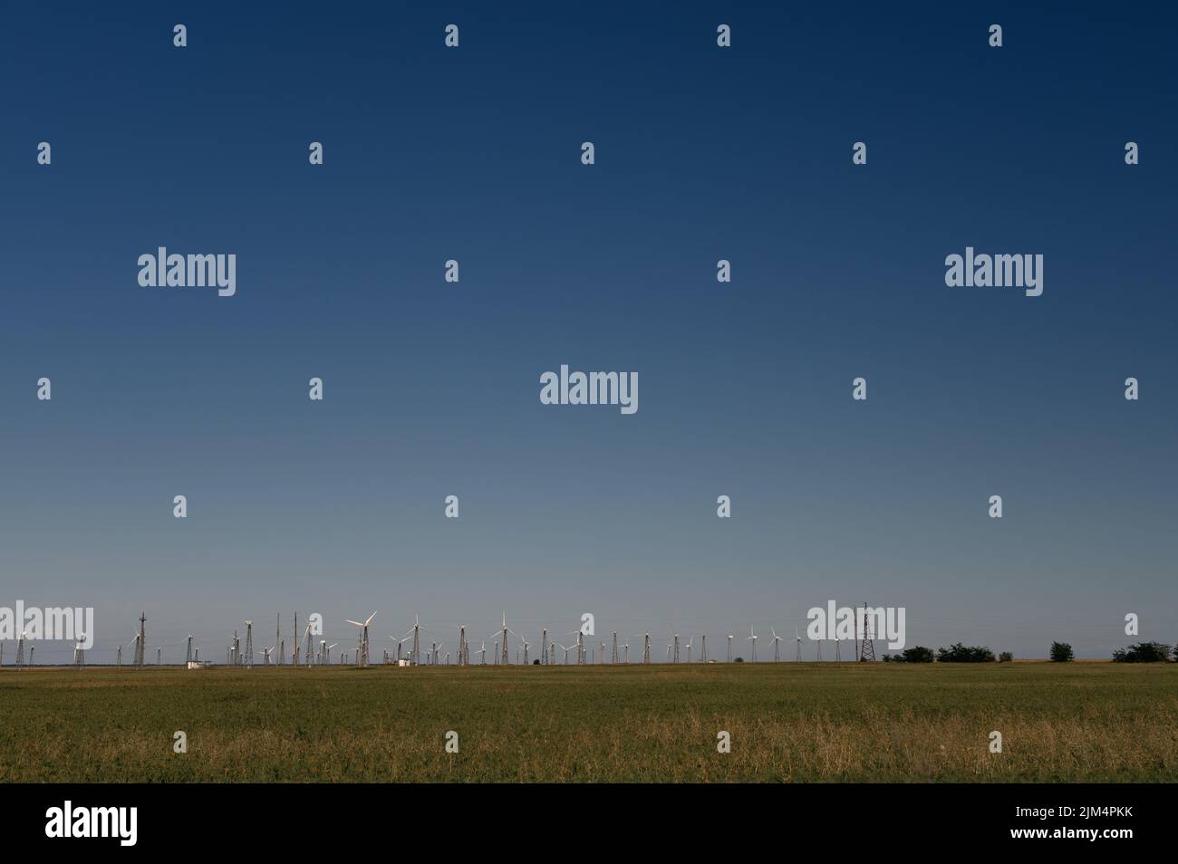 Wind Turbines Windmill Energy Farm on green field and blue sky Stock ...