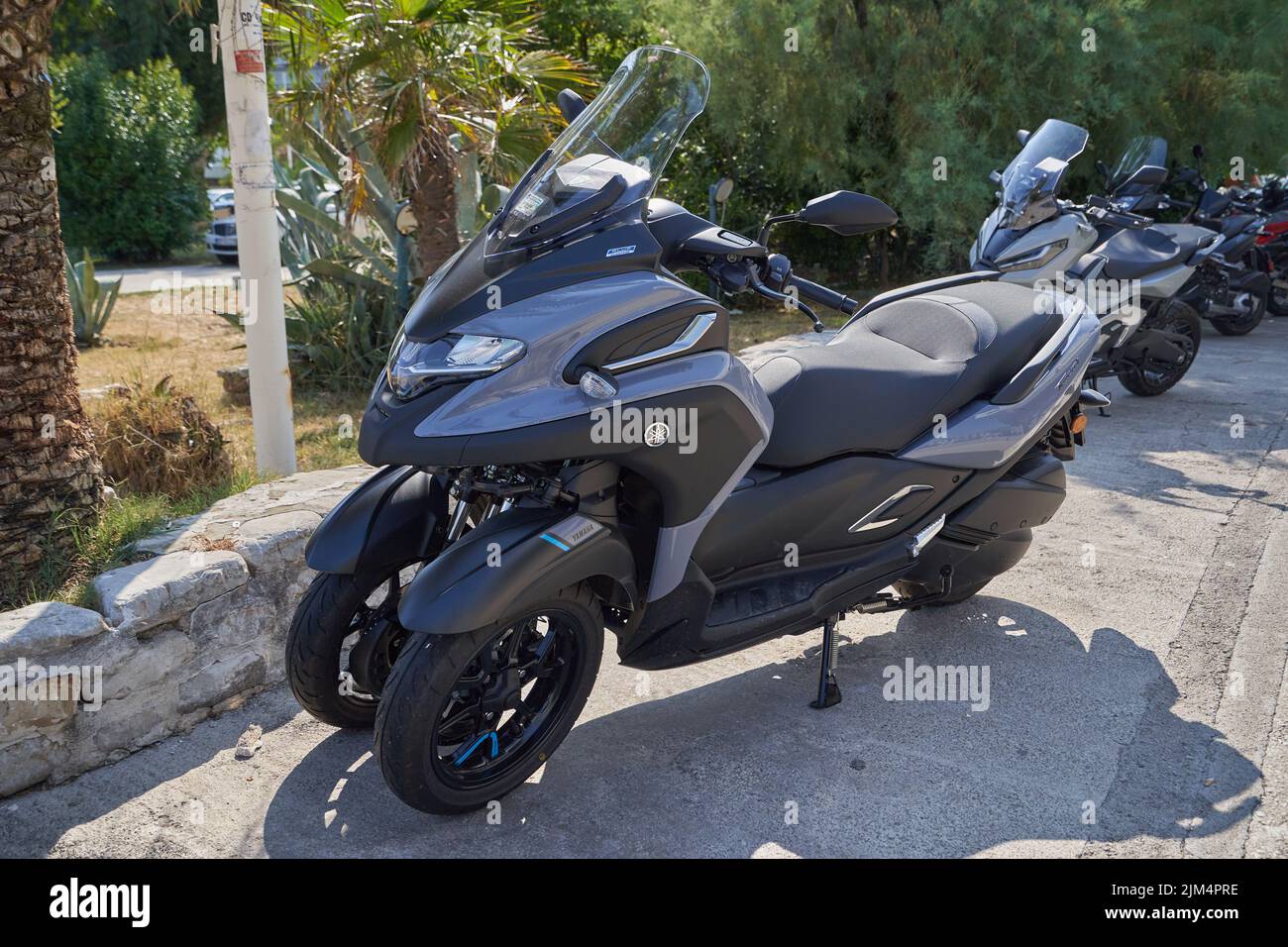 Parked motor scooter of Yamaha Tricity with three wheels Stock Photo