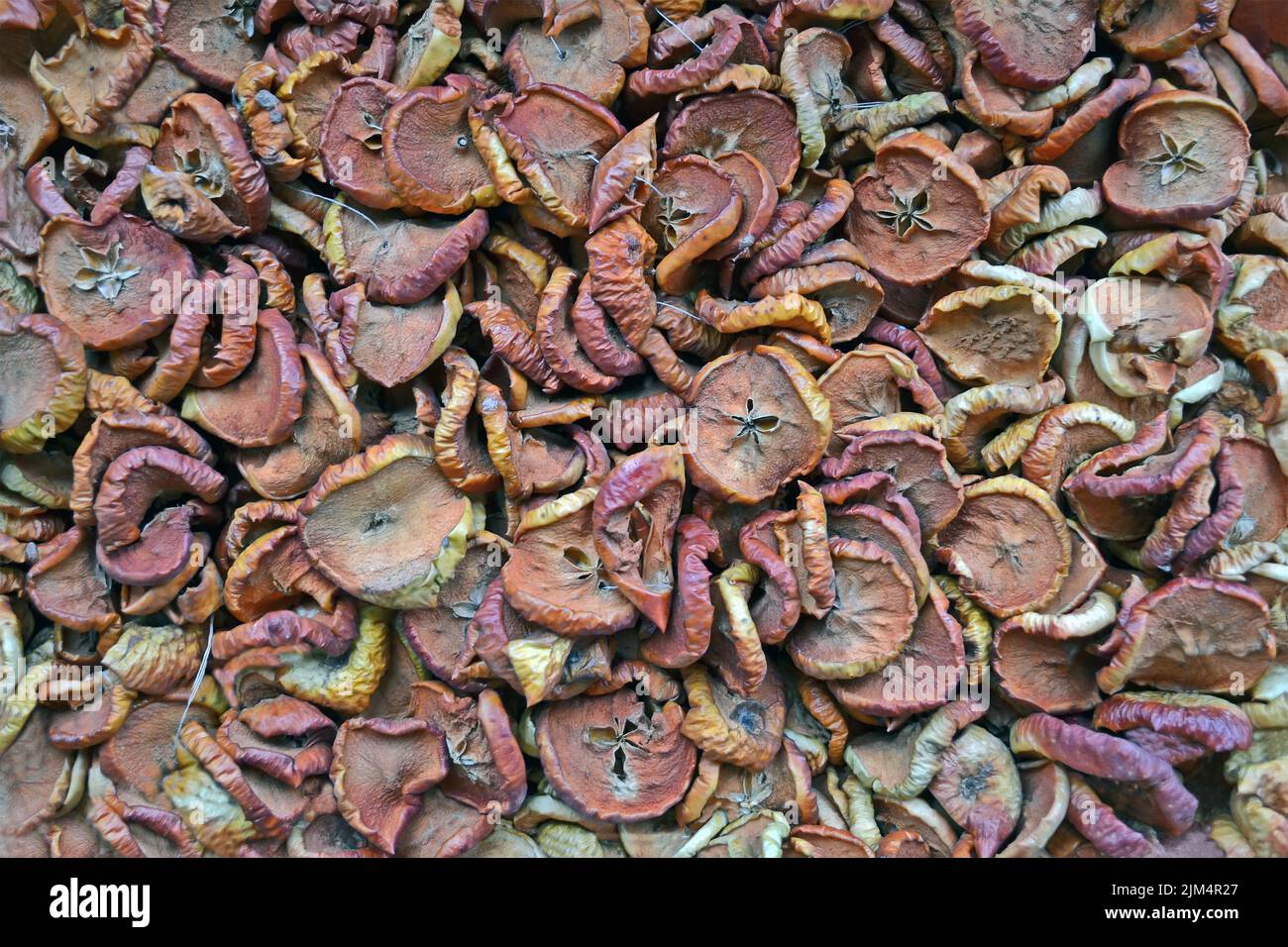 abstract dry apple pieces pile closeup, natural food background diversity Stock Photo