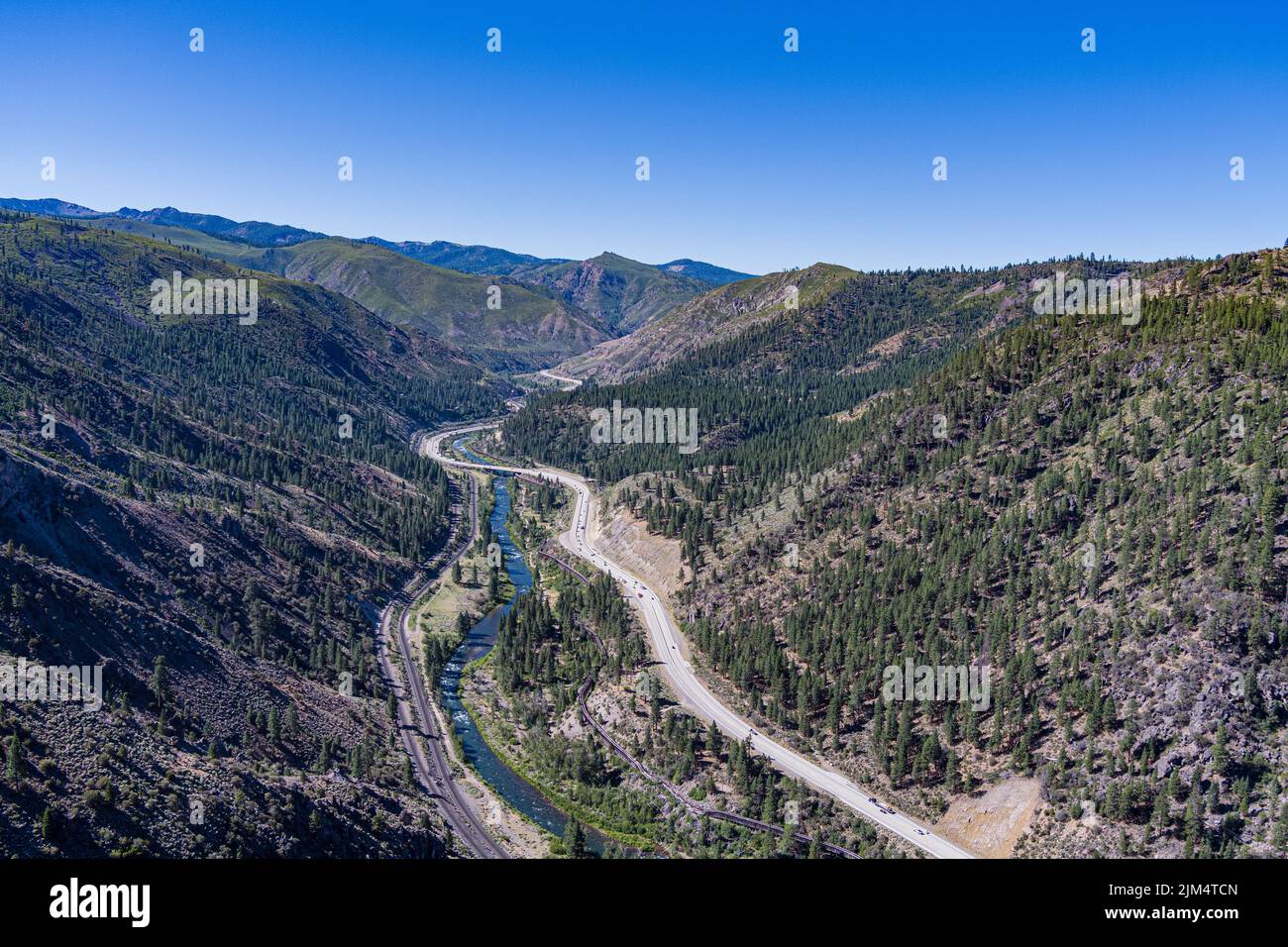 Truckee River, Interstate 80 and railroad lines run through a deep canyon between Truckee California and Reno Nevada. Stock Photo