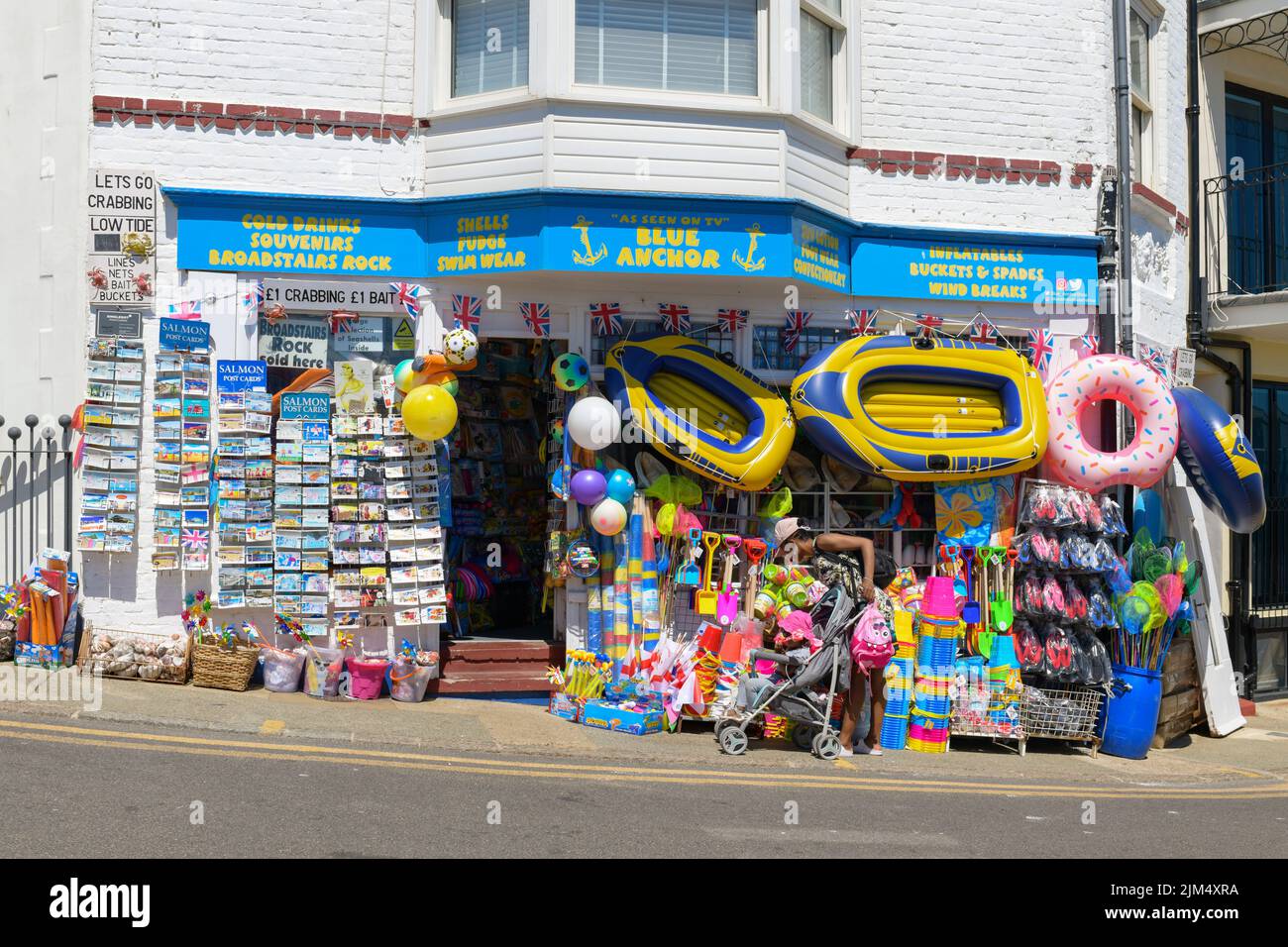 Traditional british seaside shop selling postcards, buckets and spades, inflatables and wind breaks - Blue Anchor, Broadstairs, Kent, England, UK Stock Photo