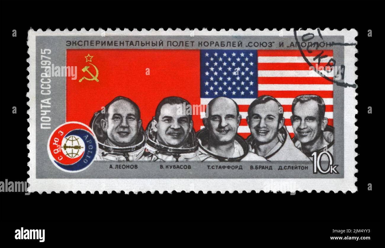 astronauts from the Apollo-Soyuz Test Project as 1st joint flight of the USA and USSR, circa 1975. stamp printed in USSR. American and USSR flag. Stock Photo