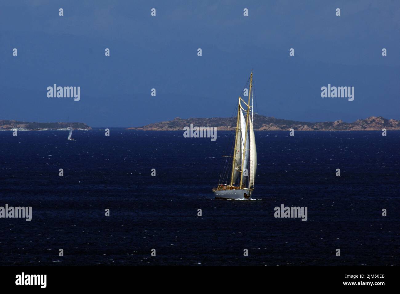 Luxury sailboat Chronos approaching at Porto Rafael Bay, Palau, Sardinai, Italy Stock Photo