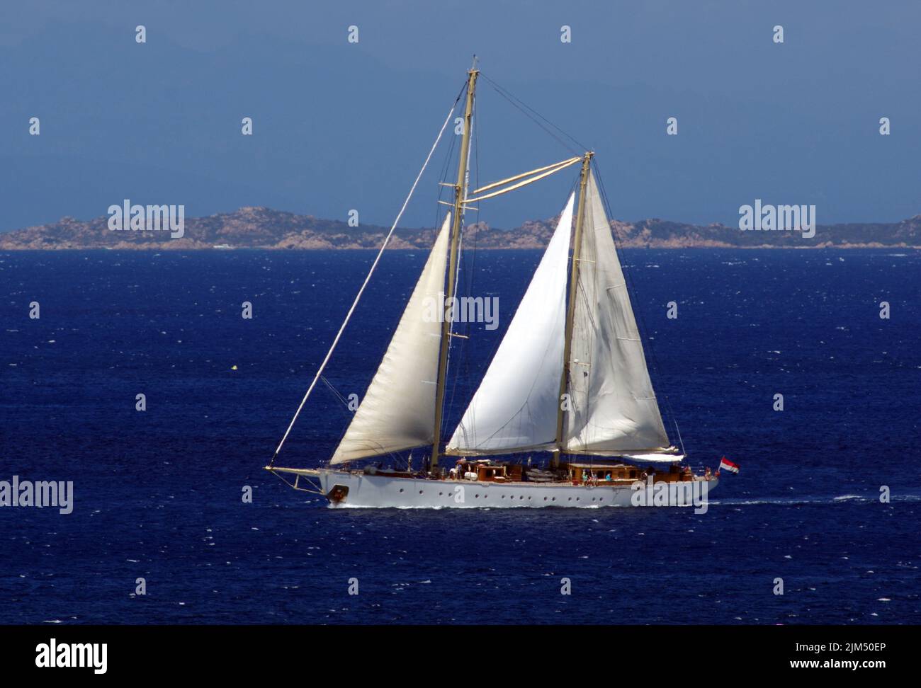 Luxury sailboat Chronos approaching at Porto Rafael Bay, Palau, Sardinai, Italy Stock Photo