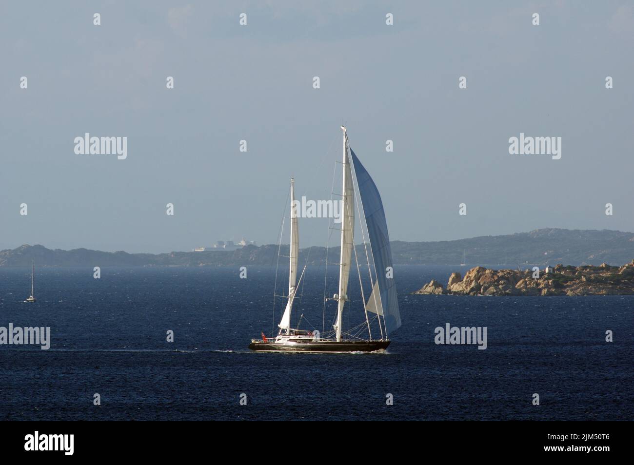 Luxury sailboat Drumbeat in transit in front of  Palau, Sardinai, Italy Stock Photo