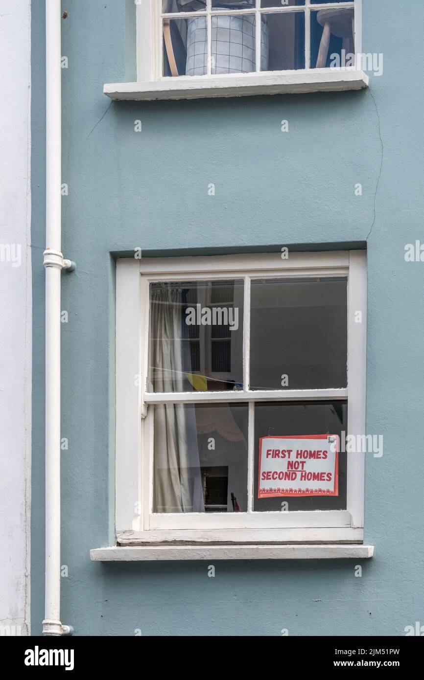 First Homes not Second Homes notice displayed in front window of old house in Lostwithiel, Cornwall in reference to Cornwall's second home owners. Stock Photo