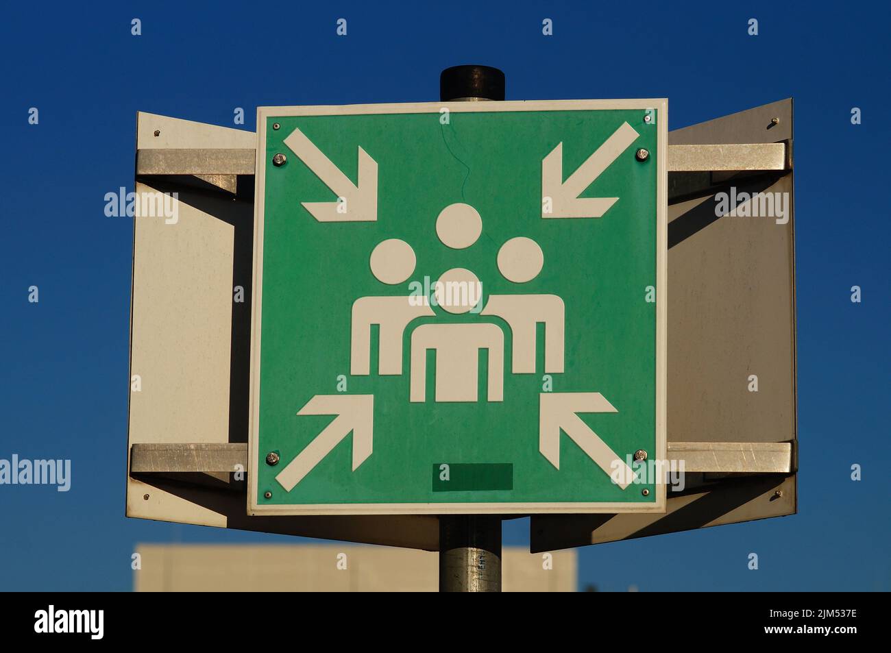 Sign for an evacuation assembly point on a university campus. Sign E007 ...
