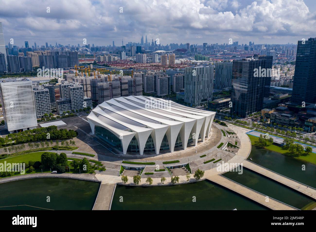 A long exposure of the Shanghai Oriental Sports Center with the cityscape in the background, China Stock Photo