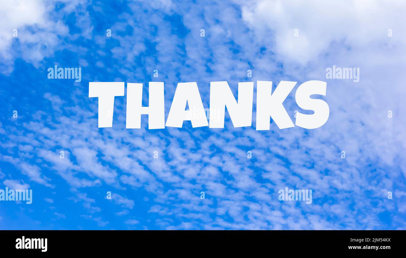 The word Thanks written on blue sky Stock Photo