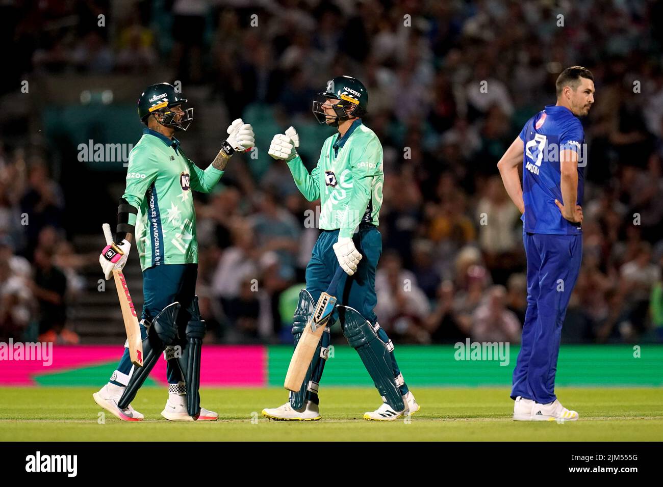 Oval Invincible's Danny Briggs, (centre) and teammate Sunil Narine, (left) as London Spirit's Chris Wood looks on during The Hundred match at The Kia Oval, London. Picture date: Thursday August 4, 2022. Stock Photo