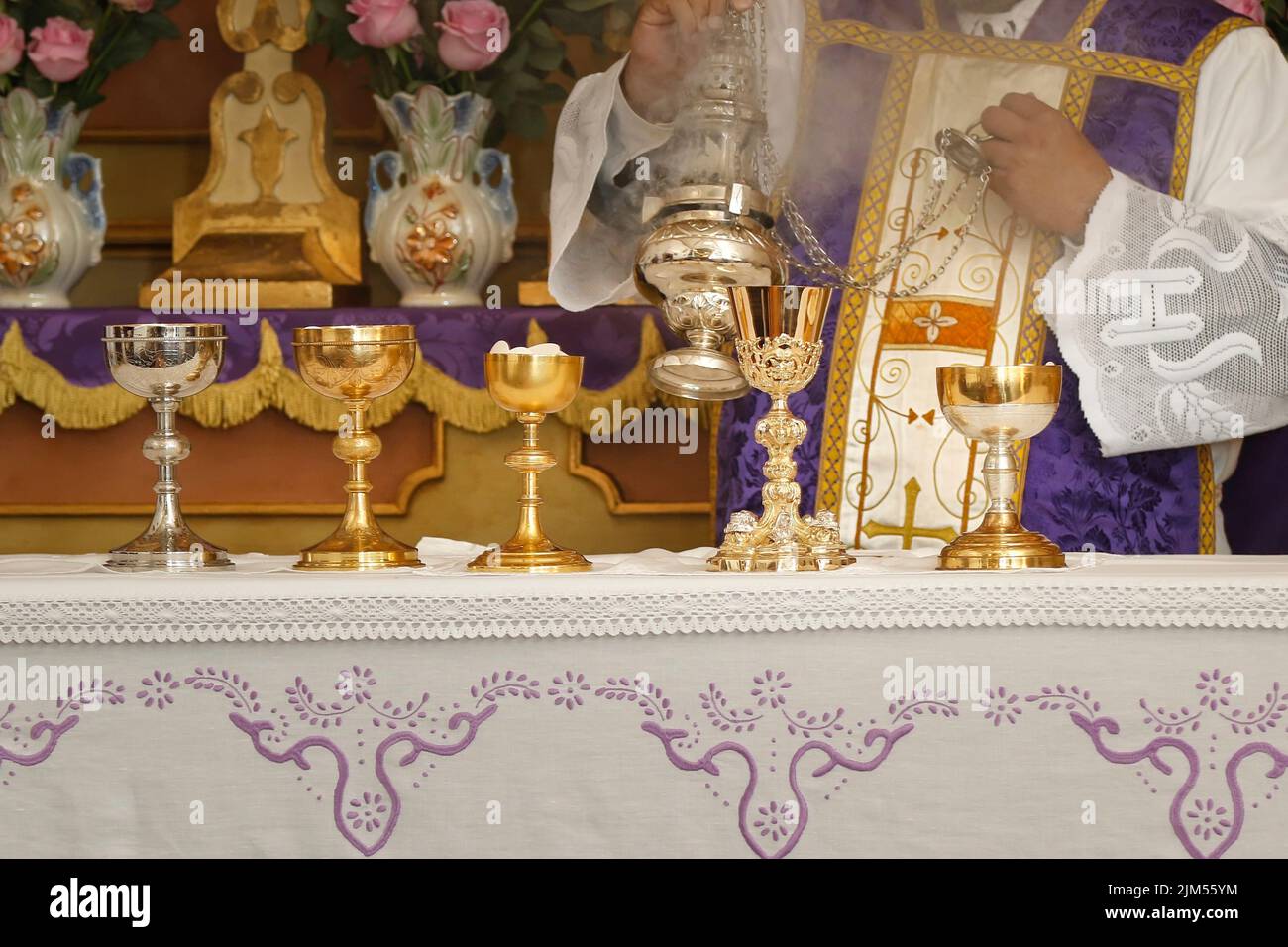 Chalice and ambula being incensed, rite of the holy mass - Consecration of bread and wine in the body and blood of Jesus - Sacred Host Stock Photo