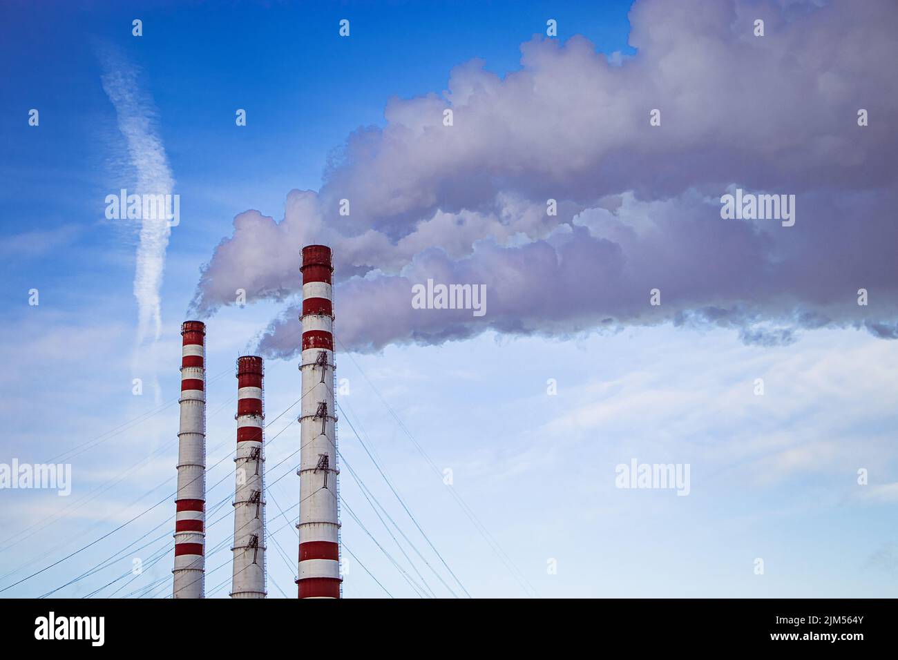 Air pollution. Thick smoke from chimneys in industrial plant