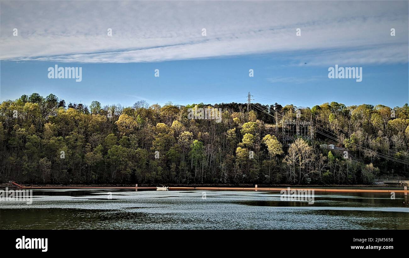 Lone Boat floats on Leesville Lake near Dam. a Bit of one side of the