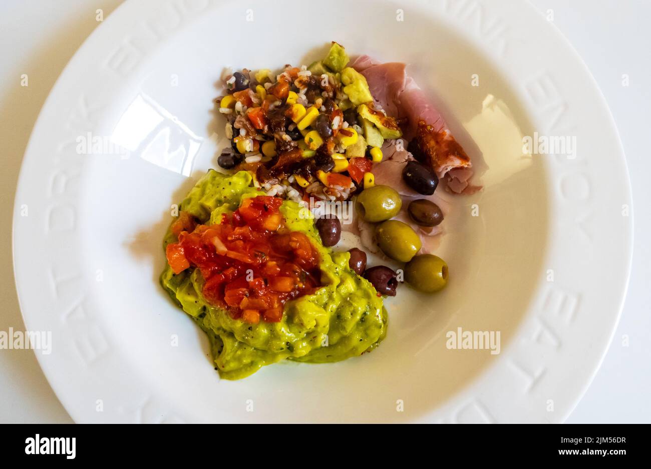 Mixed cold antipasti -- Mexican guacamole, Wiltshire ham, Asian rice salad, Spanish olives Stock Photo