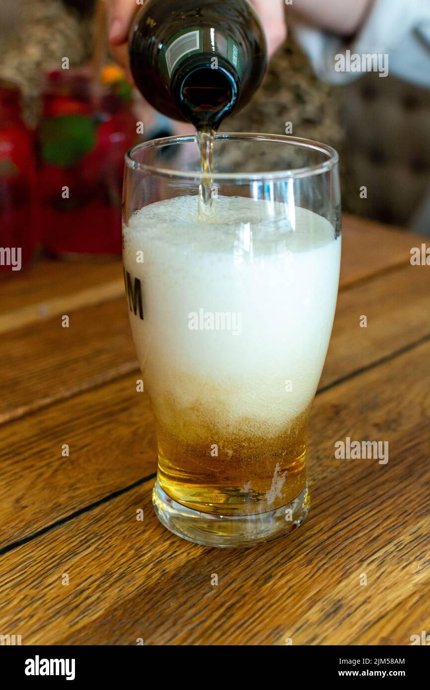 Pouring of light lager beer in glass in Polish bar Stock Photo Alamy