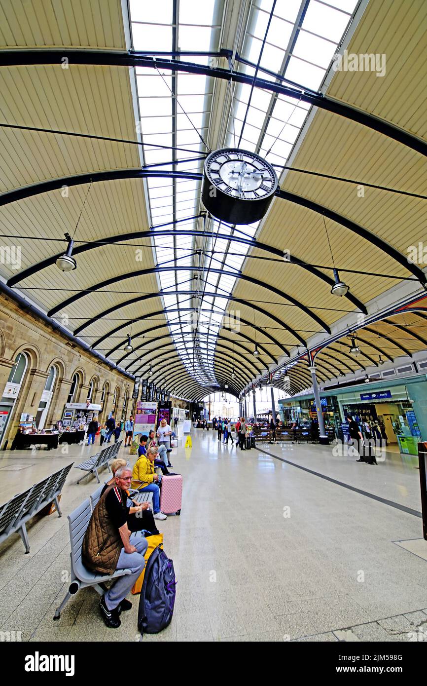 Newcastle Central Rail Station platforms amid cafes Greggs and Boots