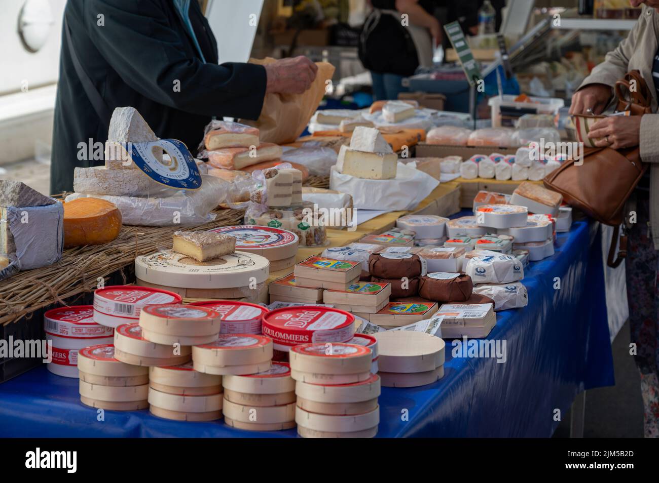 Variety of French cheeses for sale on weekly farmers market, Fecamp