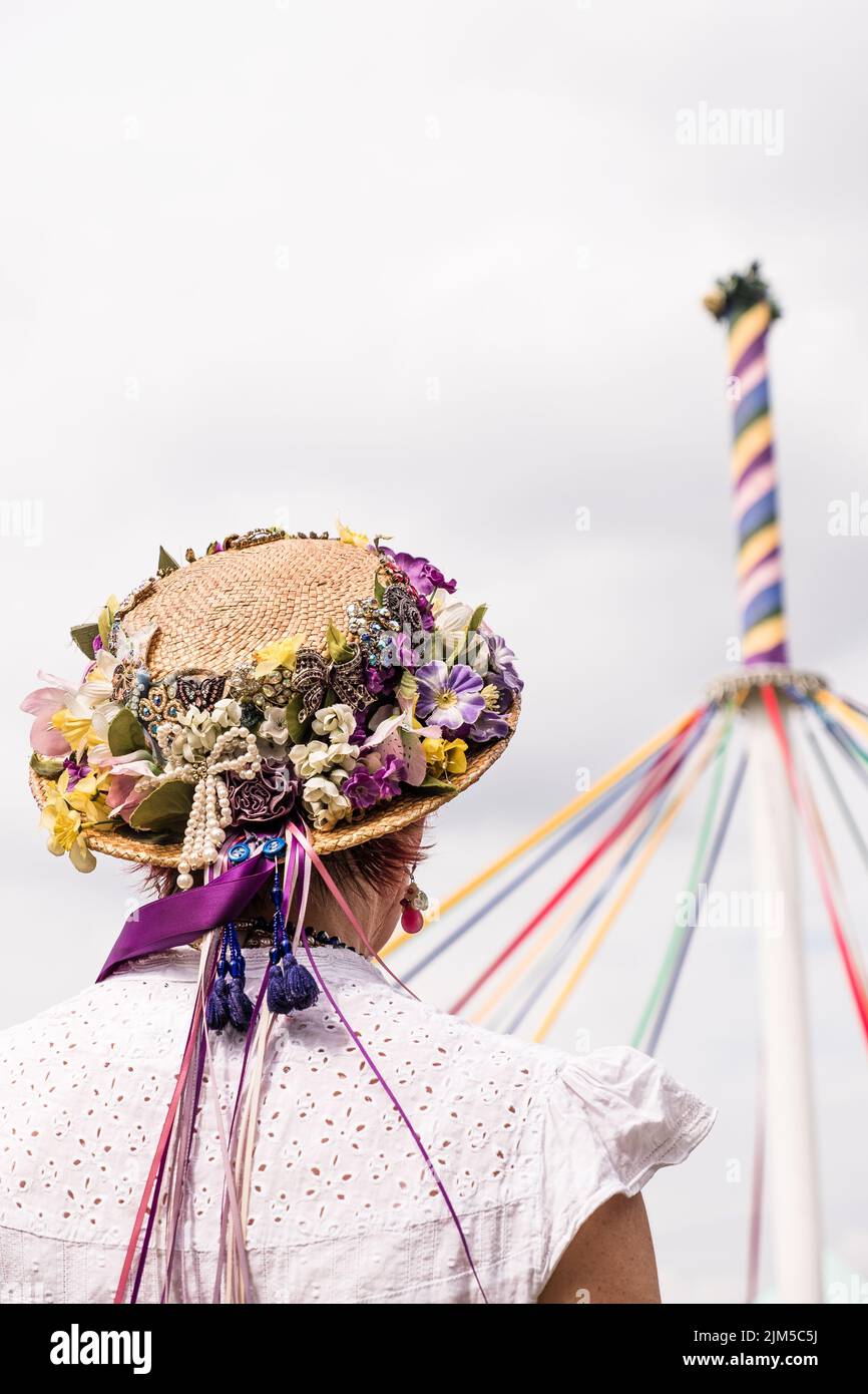 A Vertical Shot Of A Traditional English Maypole Dancer With A Floral Hat With Colorful Ribbons 9982