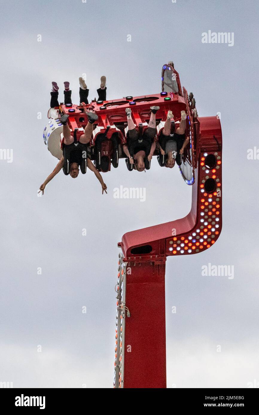 Cranger Kirmes, Herne, NRW, Germany, 04th Aug 2022. Passengers have fun on the 'Apollo 13' ride. Visitors enjoy the many attractions, roller coasters, beer halls, carousels and more at the Cranger Kirmes fun fair soft opening ahead of the official opening ceremony tomorrow. This is the first time it takes place since Covid restrictions took hold in 2020. The third largest fun-fair in Germany, and largest in Germany's most populous state NRW, usually attracts 4m  visitors over 10 days. It has a long tradition with fairs having taken place on the site since the early 18th century. Stock Photo