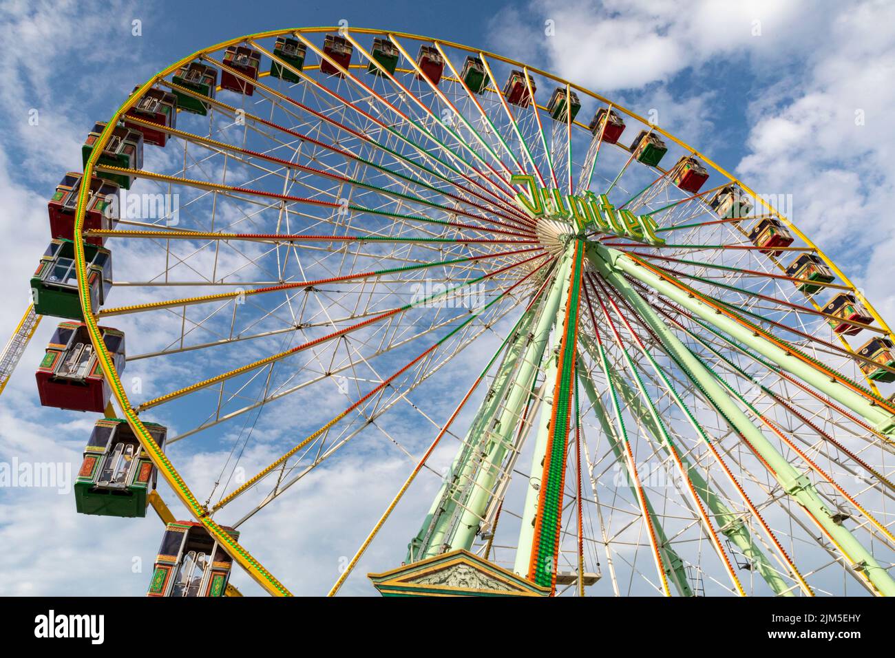 Cranger Kirmes, Herne, NRW, Germany, 04th Aug 2022. The Jupiter ferris wheel. Visitors enjoy the many attractions, roller coasters, beer halls, carousels and more at the Cranger Kirmes fun fair soft opening ahead of the official opening ceremony tomorrow. This is the first time it takes place since Covid restrictions took hold in 2020. The third largest fun-fair in Germany, and largest in Germany's most populous state NRW, usually attracts 4m  visitors over 10 days. It has a long tradition with fairs having taken place on the site since the early 18th century. Stock Photo