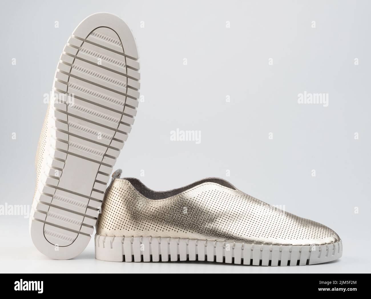 New shiny shoes with white sole isolated on studio background Stock Photo
