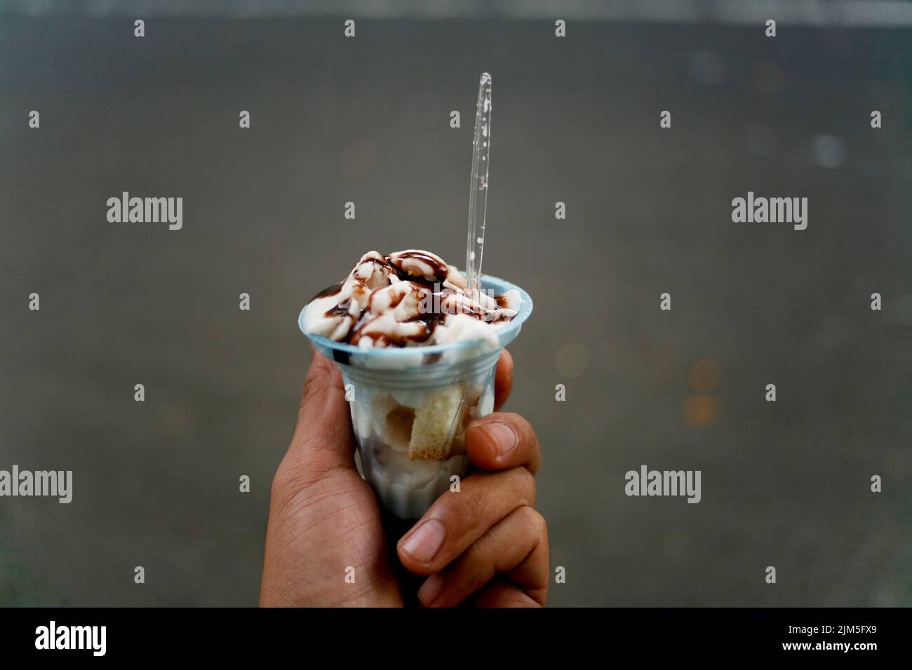 Hand holding indonesian traditional ice cream called es puter or es dong dong Stock Photo Alamy