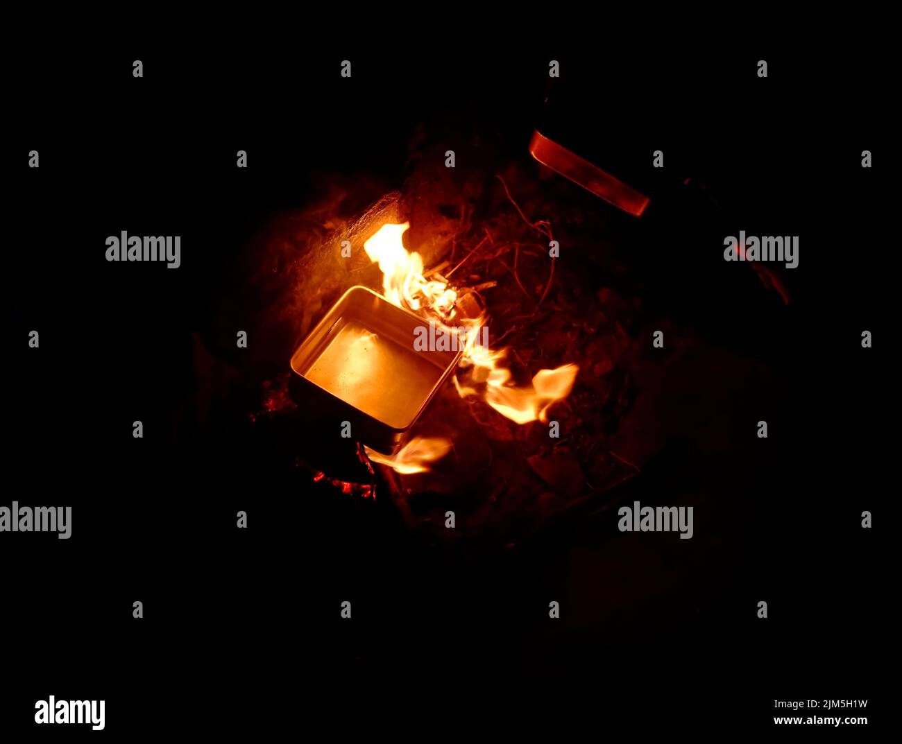 Boiling water in a campfire Stock Photo Alamy