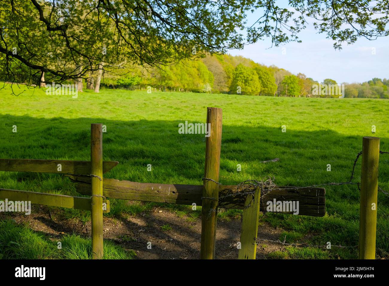 open farmland next to Monton village Eccles Manchester wooden stile leading into field Stock Photo