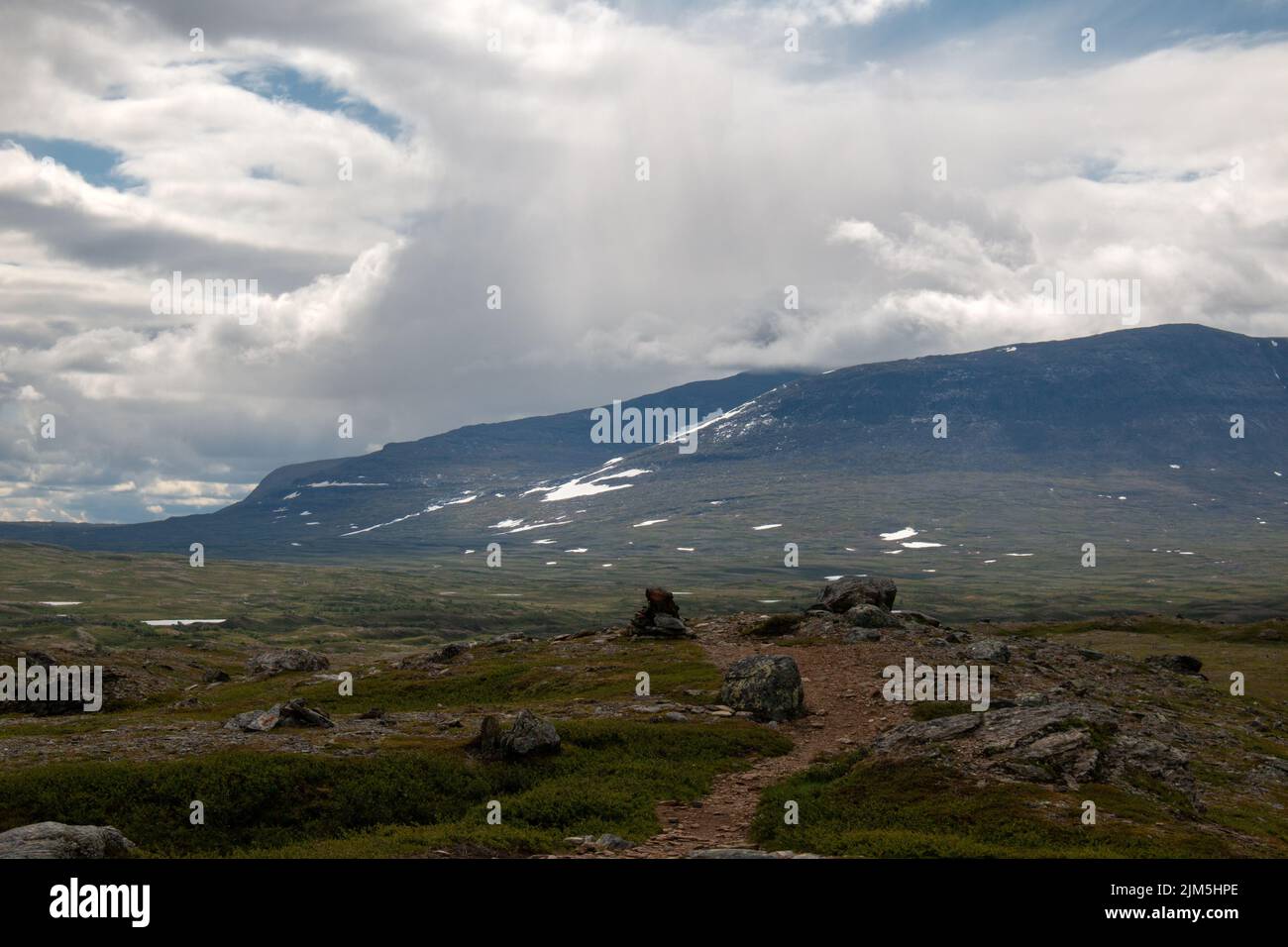 Rain clouds gathering above the hiking trail between Sylarna and Helags mountain stations, Jamtland, Sweden Stock Photo