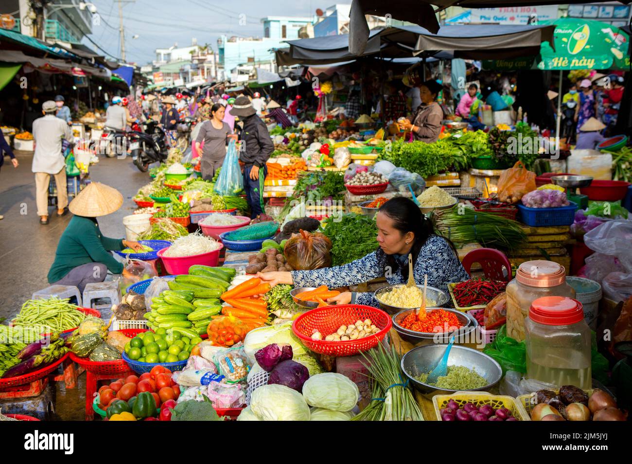 Duong Dong, Phu Quoc Island, Vietnam - January 25, 2018: Vietnamese market vendors selling fresh vegetables at the Duong Dong Market located in Duong Stock Photo