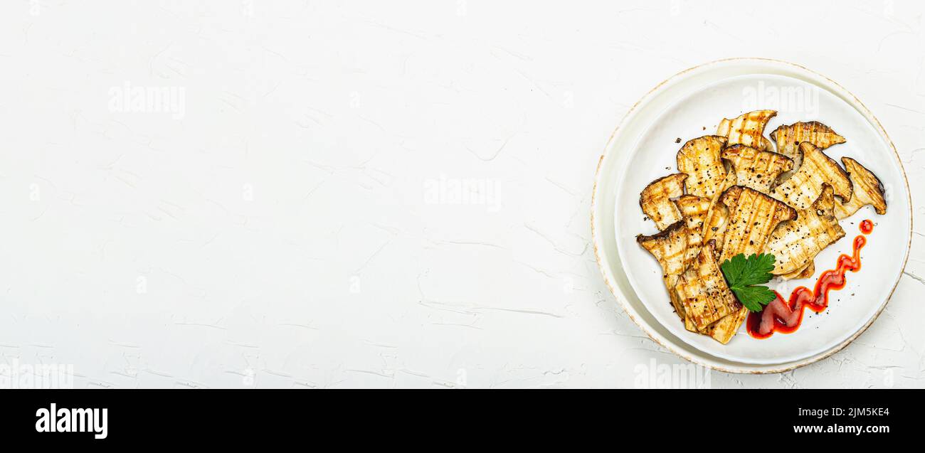 Fried slices Pleurotus eryngii mushrooms with sauce, spices and herbs