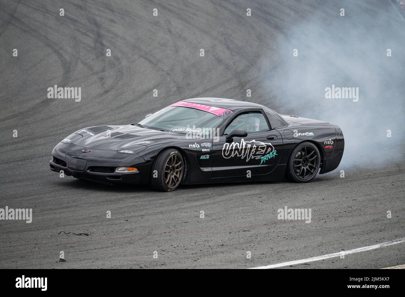 Black Chevrolet Corvette C5 drifting in the track Stock Photo