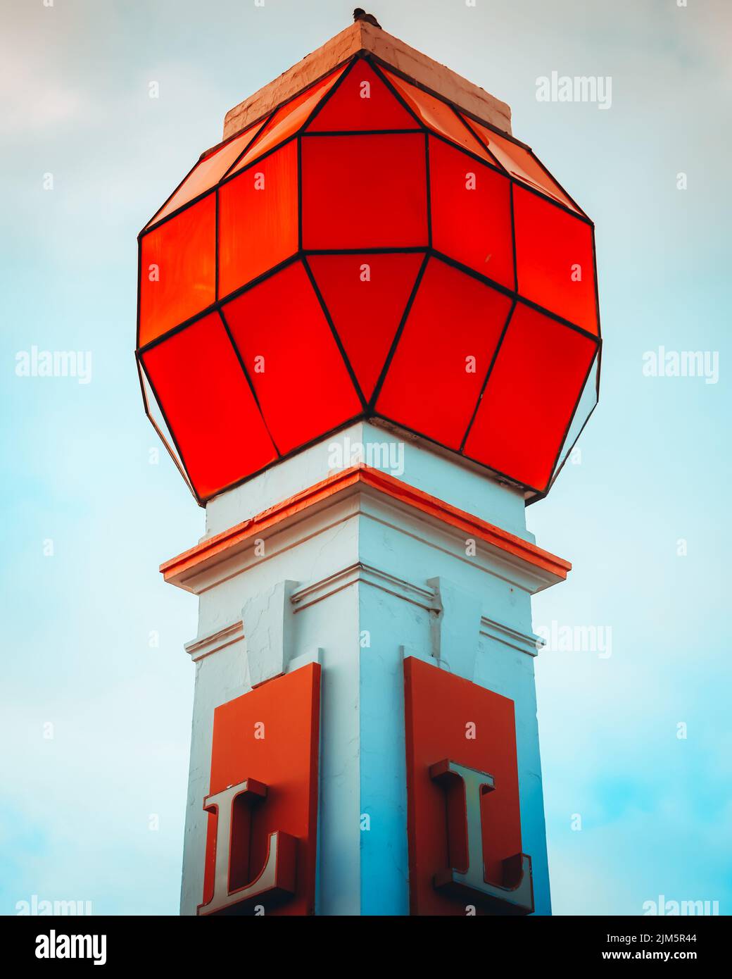 A tower with red top and letter L on its body Stock Photo