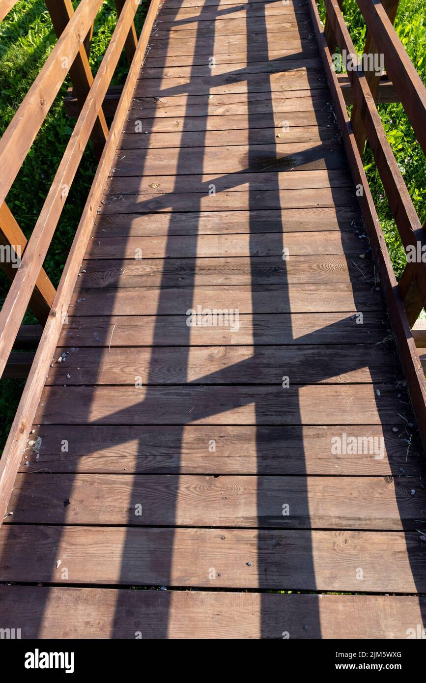details of an old wooden bridge over a small river Stock Photo