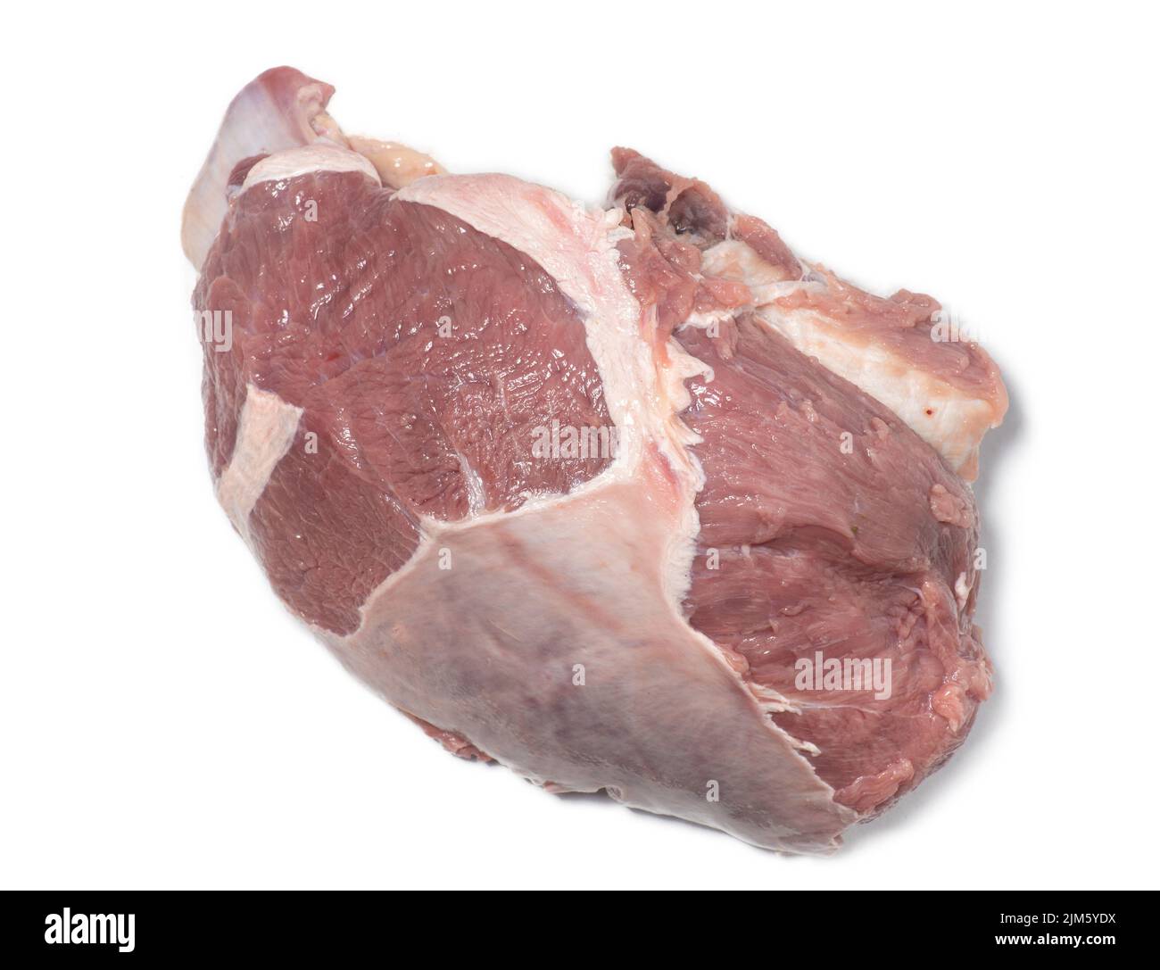 A piece of raw beef on a white background. Juicy meat with veins. Unprepared product. Beef isolate. An ingredient for a hearty meal. Cooking Stock Photo