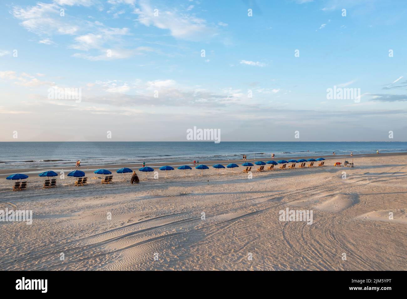 A bird'seye view of deck chairs with blue umbrellas at Hilton Head