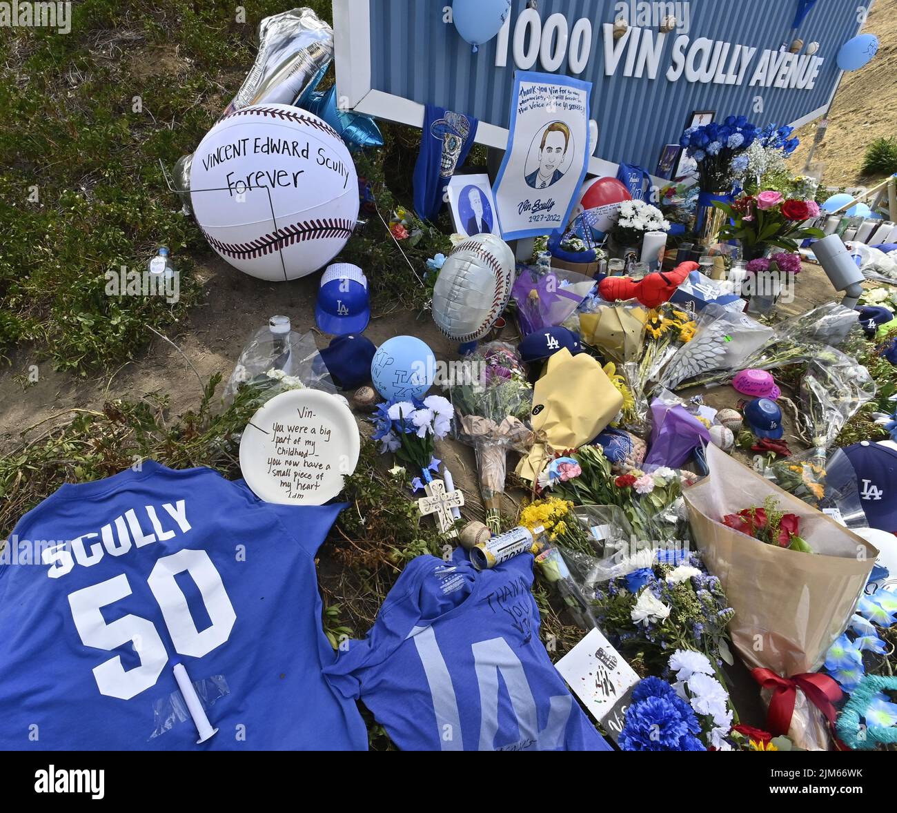 Los Angeles, United States. 04th Aug, 2022. Dodger fans pay their respects to sportscaster Vin Scully at a makeshift memorial at the entrance of Dodger Stadium on Thursday, August 4, 2022. Scully, the legendary Los Angeles Dodgers broadcaster, who serenaded baseball fans with his voice for nearly seven decades as the radio soundtrack for Los Angeles Dodgers games, died Tuesday at 94. Photo by Jim Ruymen/UPI Credit: UPI/Alamy Live News Stock Photo