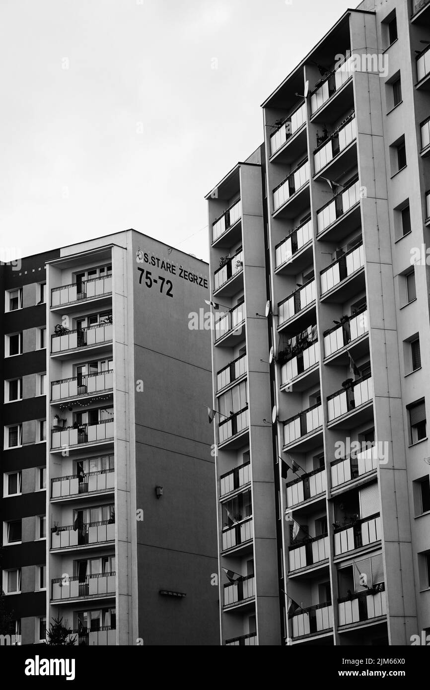 A vertical grayscale shot of high apartment buildings with balconies in the Stare Zegrze district. Stock Photo