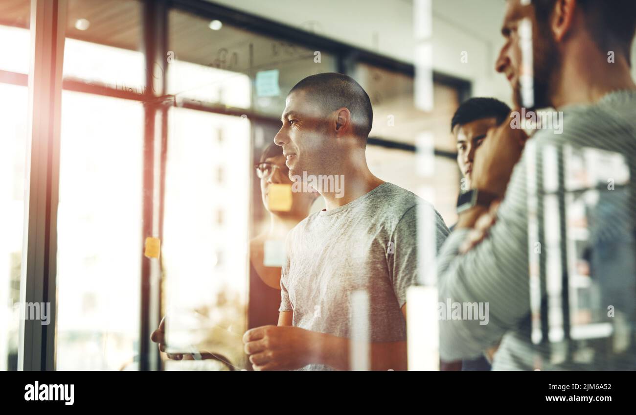 Team of employees brainstorming and planning together in a meeting