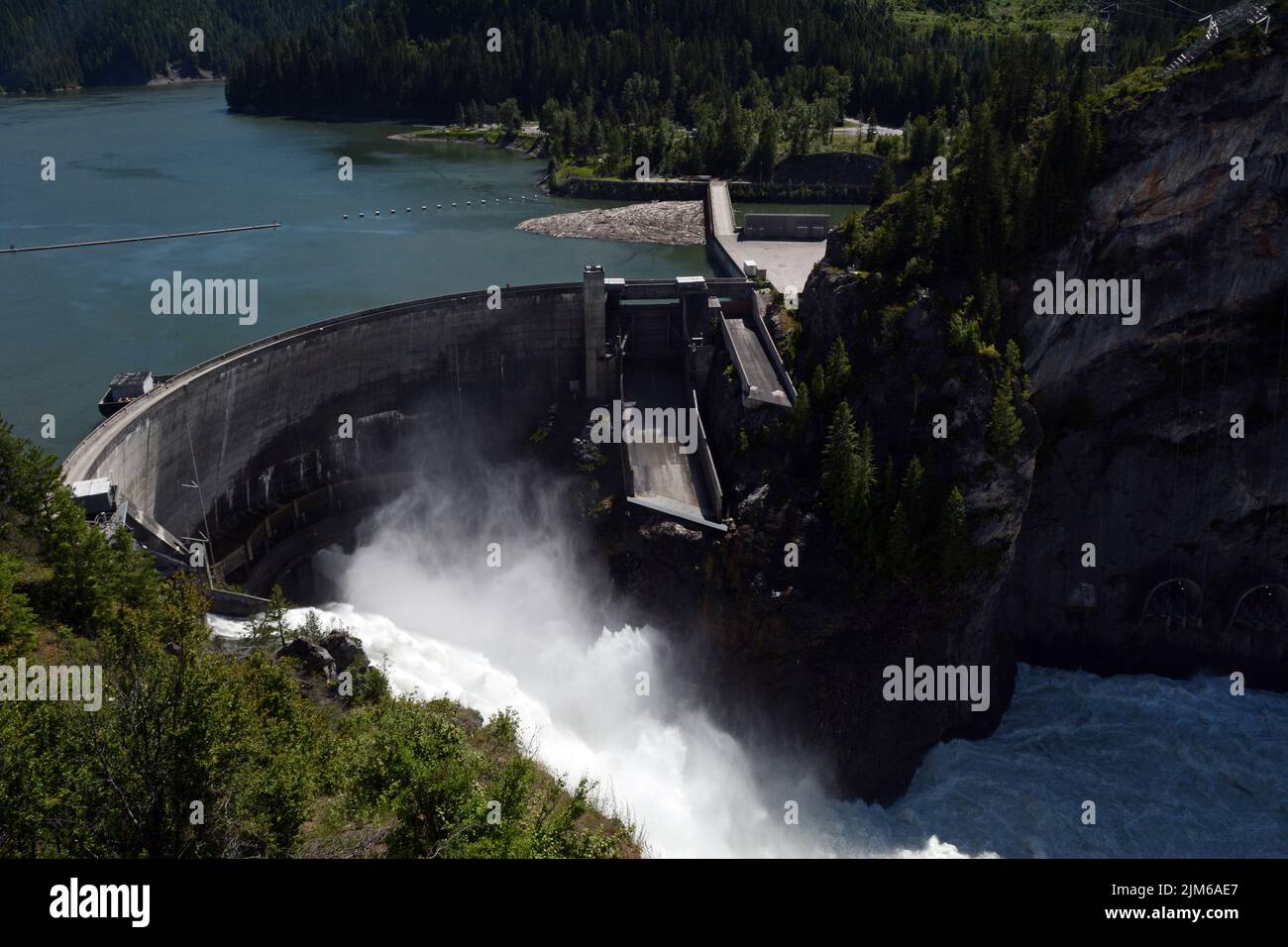 Aerial view of the concrete arch hydroelectric Boundary Dam spilling