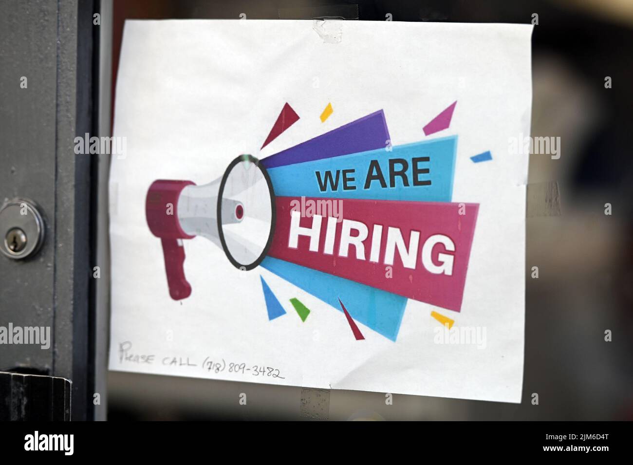 New York, USA. 04th Aug, 2022. A hiring sing is taped to the window of
