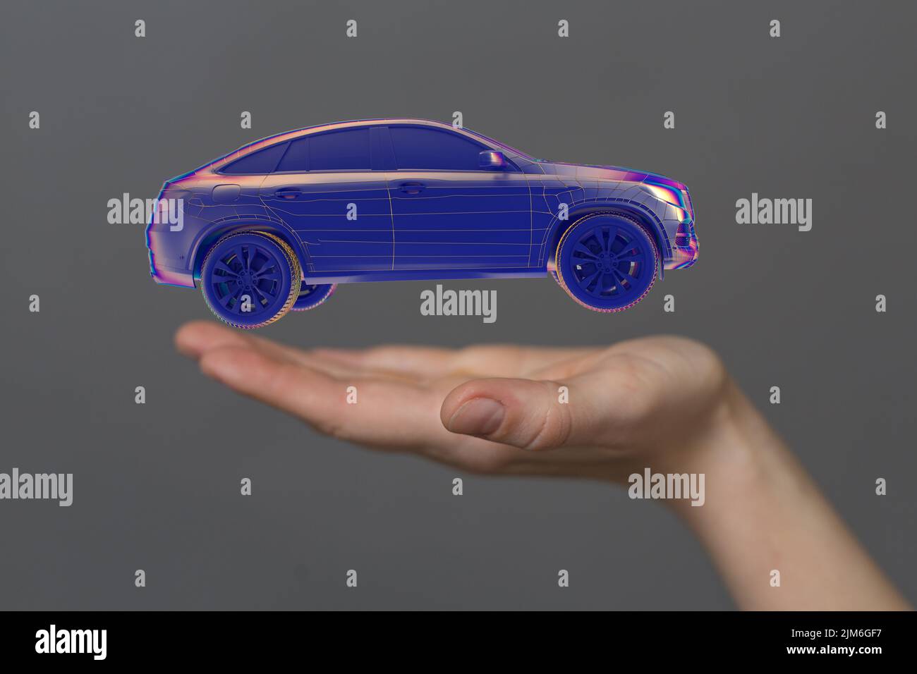 A hand showing the hologram of a 3D rendered futuristic autonomous car concept Stock Photo