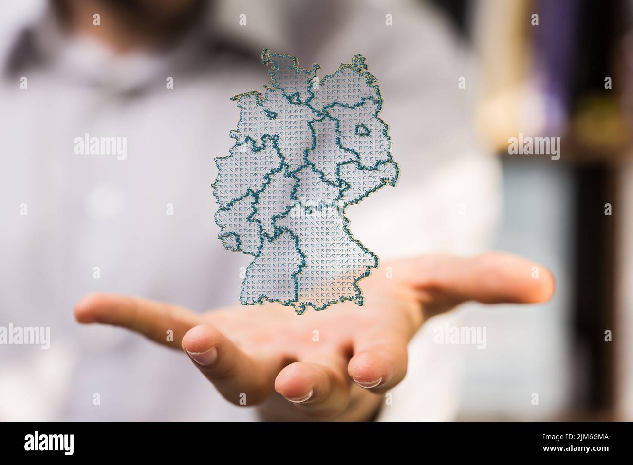 A 3D render of a German map on a male hand with blurred background Stock Photo