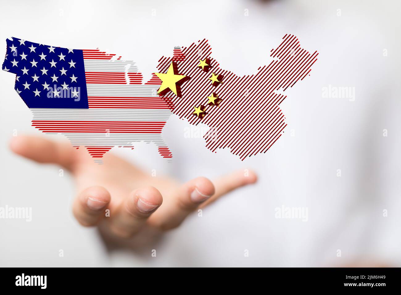 A blurred man holding USA and China trade partner maps the concept of ...