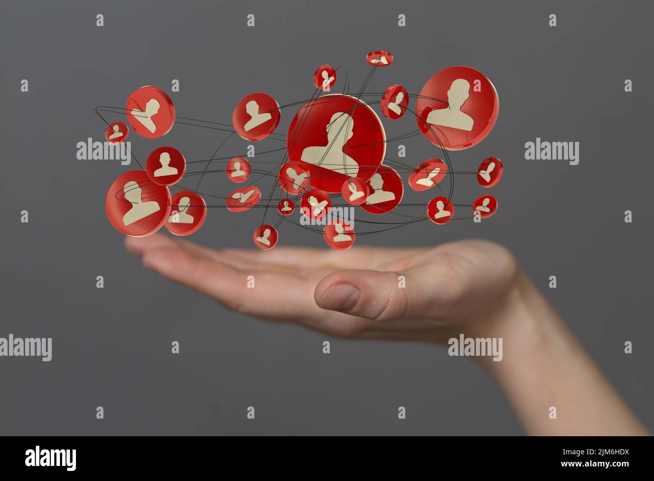 A businessman holding a floating digital render of red profile icons